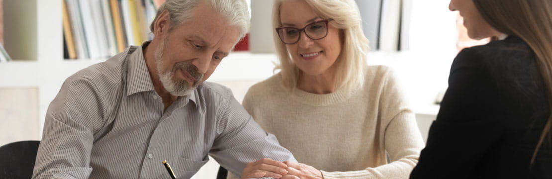 an elderly couple with an advisor