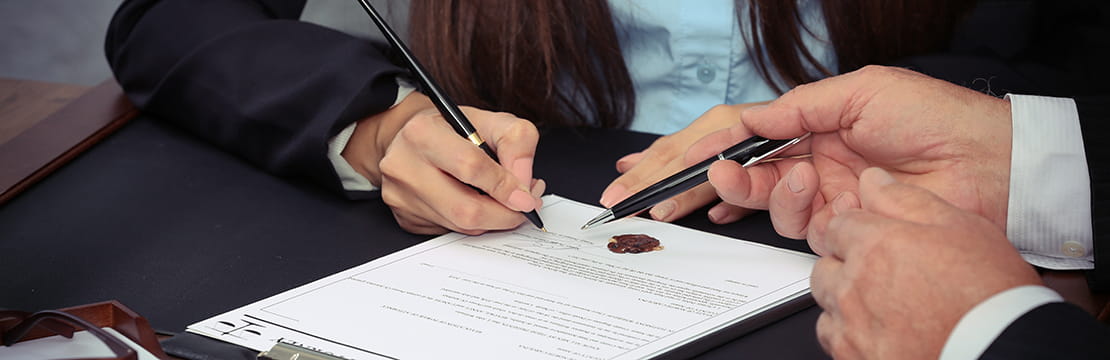 A person signing a legal paper.