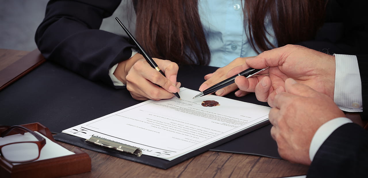 A person signing a legal paper.