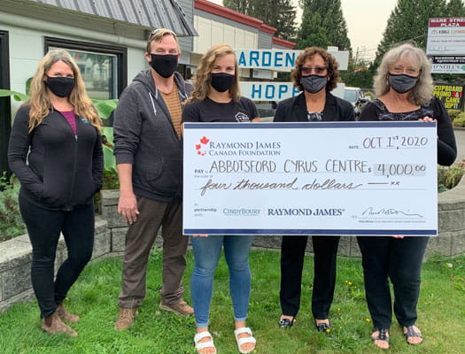 Cindy and team giving a $4,000 check to the Abbotsford Cyrus Centre